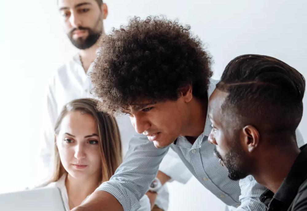 CIOB Staff discussing topic over laptop 1000.jpg